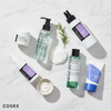 Best Korean skincare products UAE featuring COSRX snail cream BHA liquid AHA BHA toner Some By Mi ISNTREE sunscreen flat lay